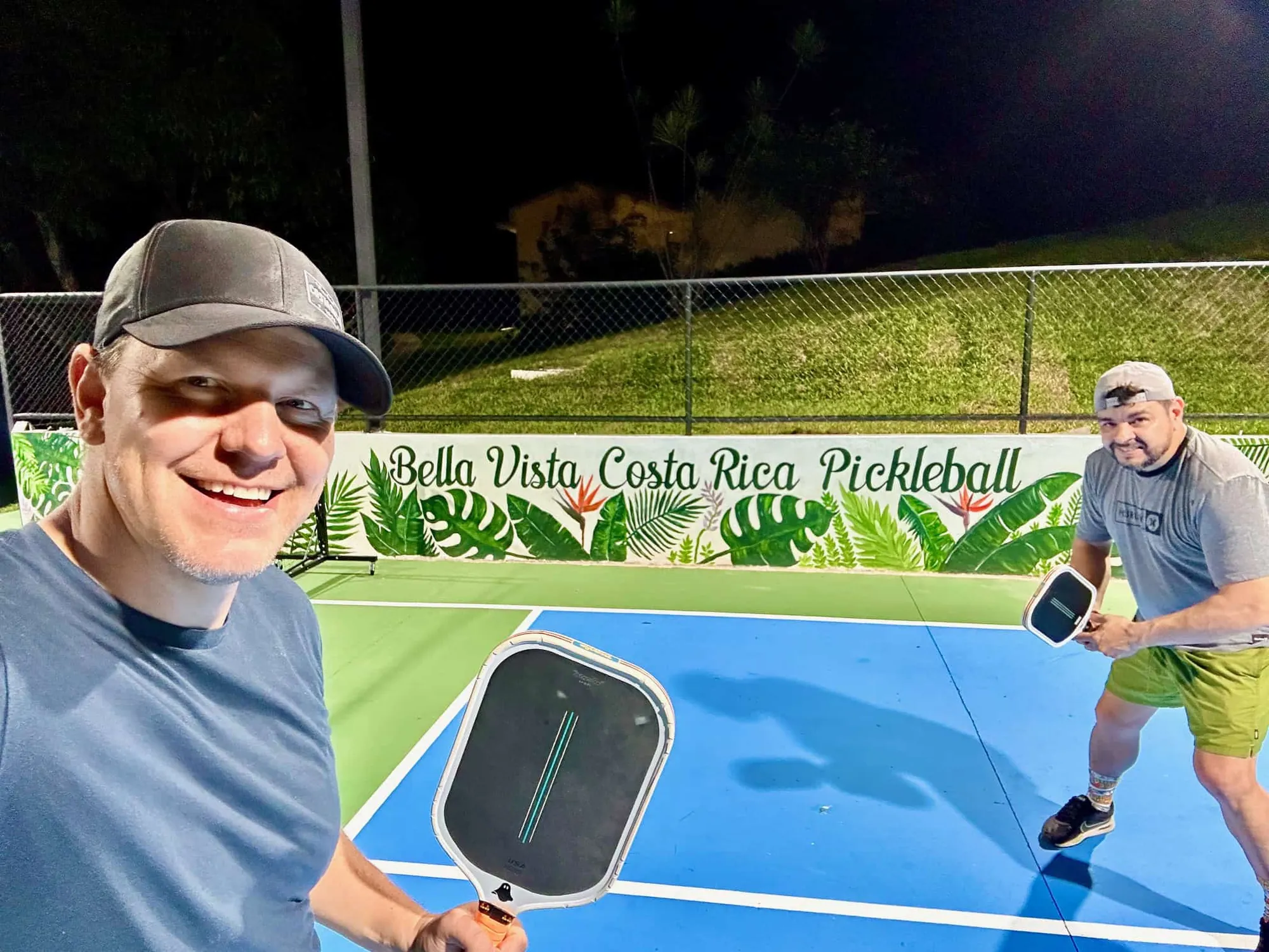 Two players with paddles on the Bella Vista Costa Rica pickleball courts